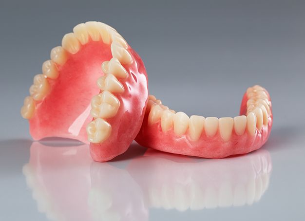 Full set of dentures resting on a table