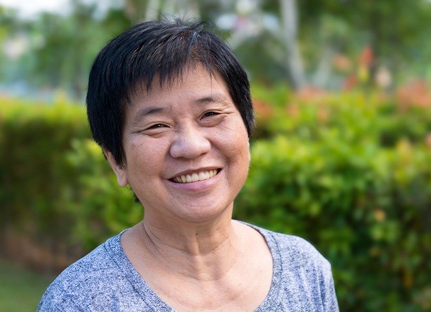 Older woman sharing full smile after dentures