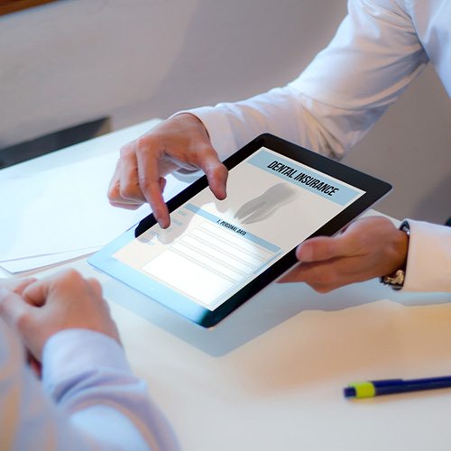 Patient reviewing dental insurance form on tablet