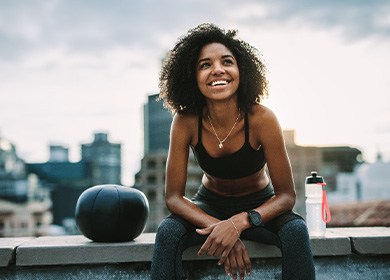 Patient smiling with dental implants during workout