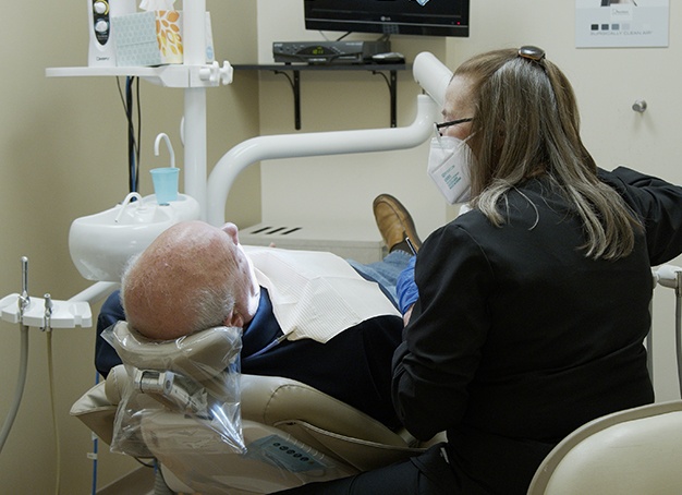 Dental team member talking to new dental patient