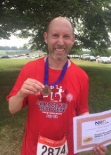 Doctor Rauchberg holding up a medal after a race event