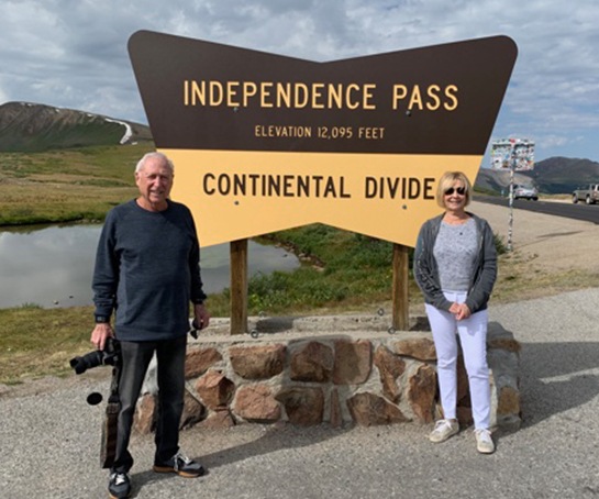 Doctor Rauchberg and his wife in front of Continental Divide sign