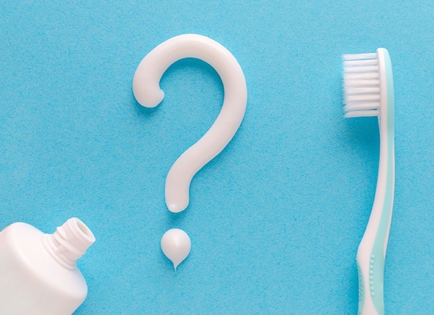 Question mark written in toothpaste signifying dental emergency frequently asked questions