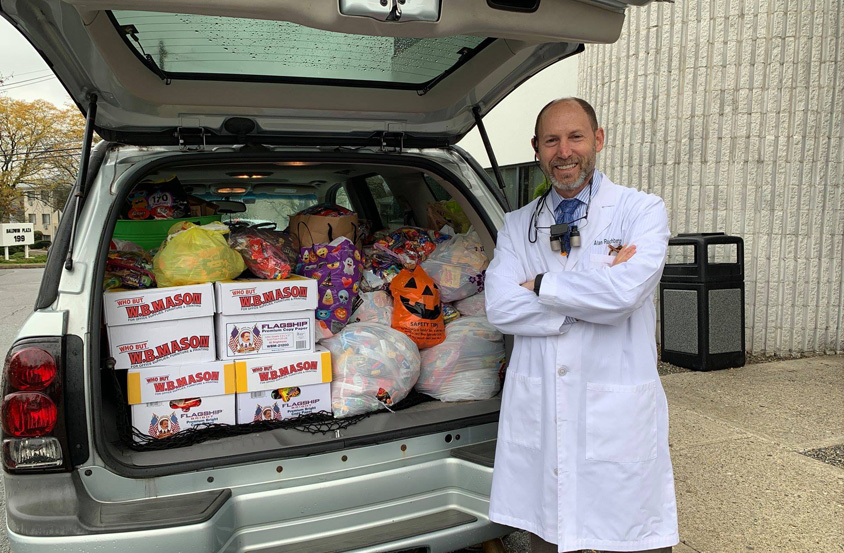 Doctor Rauchberg with trunk full of candy after Halloween candy drive