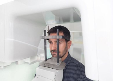 Dental patient positioned inside CBCT machine