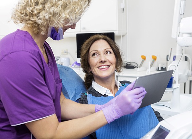 dentist explaining the cost of dental implants to a patient