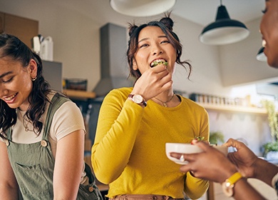 Group of friends enjoying meal in kitchen