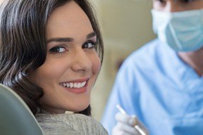 Woman smiling while discussing the mouth body connection with her dentist