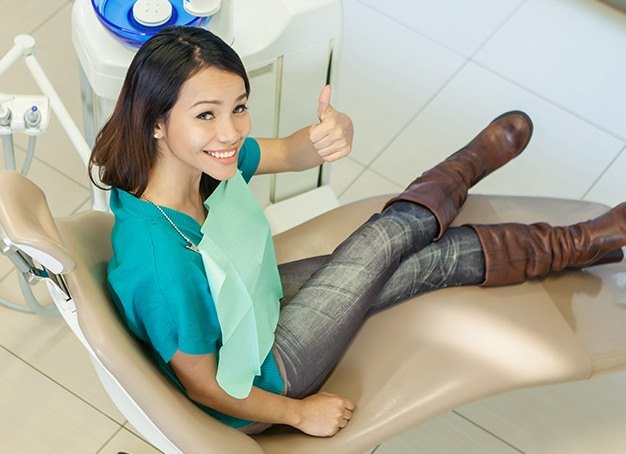 Woman smiling after dental checkup and teeth cleaning visit