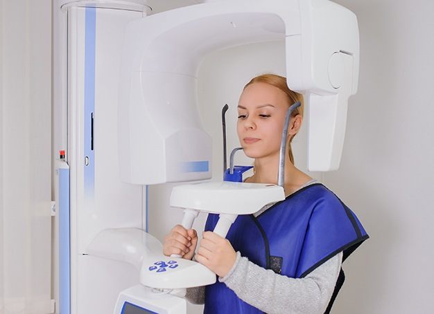 Patient receiving x-rays in C B C T scanner