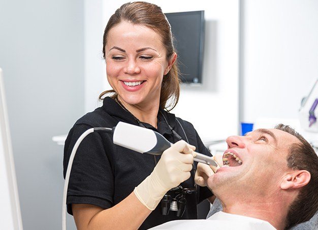 Dental team member using cavity detection system