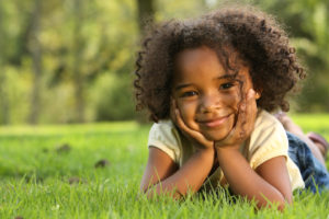 child posing in the grass
