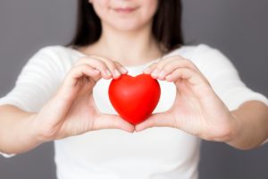 girl holding heart