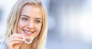 a young girl inserting her Invisalign aligner