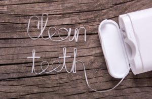 dental floss spelling "clean teeth"