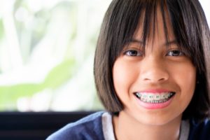 a young girl wearing traditional braces