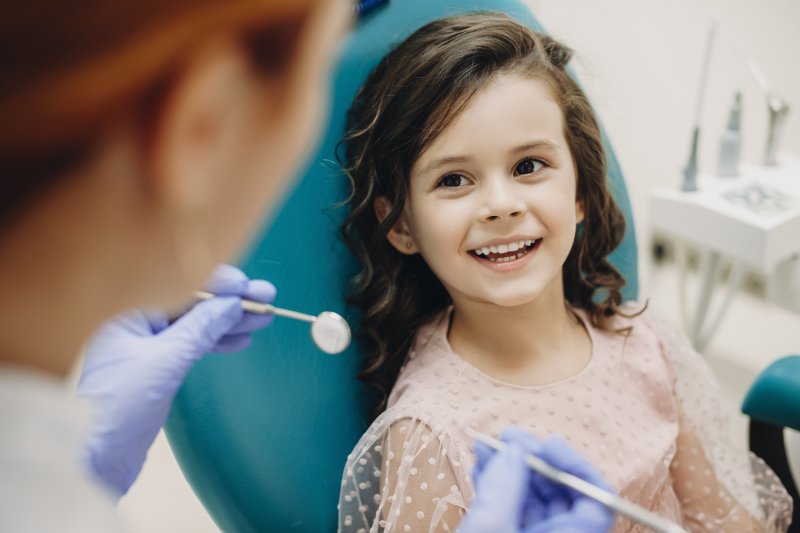 Child smiling at family dentist