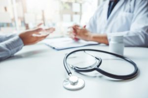 dentist and patient discussing medical issues at dental checkups