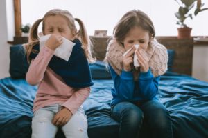 Little girls sneezing during cold and flu season