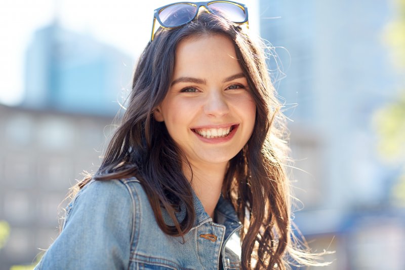 young woman smiling after braces are removed