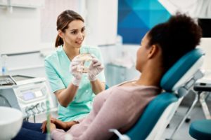 orthodontist showing patient their x-ray 