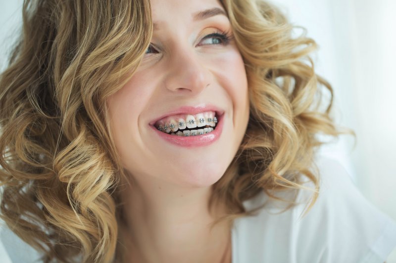 A young woman smiling with braces