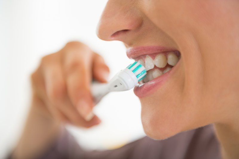 closeup of someone brushing their teeth