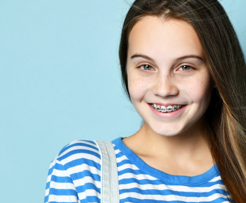 young teen smiling with their braces