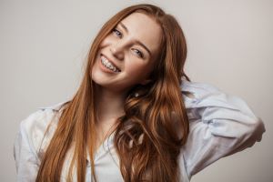 young adult smiling with braces