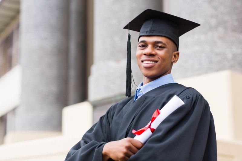 graduate smiling in a cap and gown