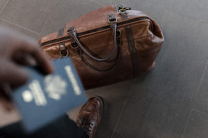 Man holding passport with luggage