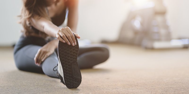 A young woman stretching her legs before exercising