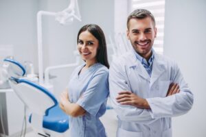 Dentist and dental hygienist smiling
