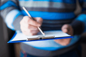 Patient with a clipboard filling out his health history