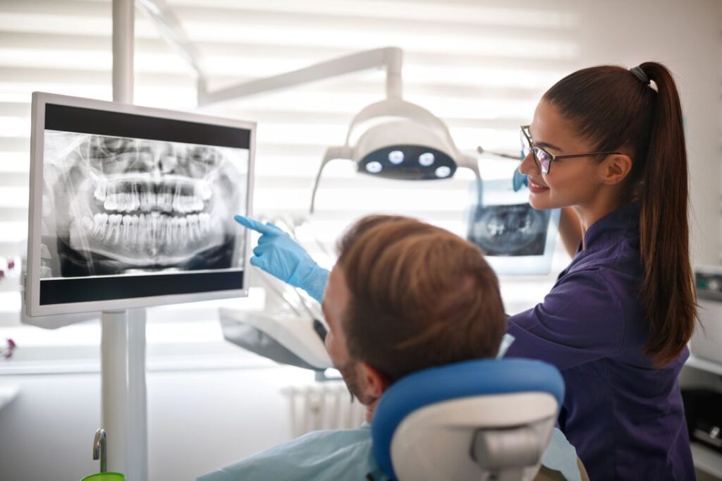 An orthodontist showing a patient their X-rays
