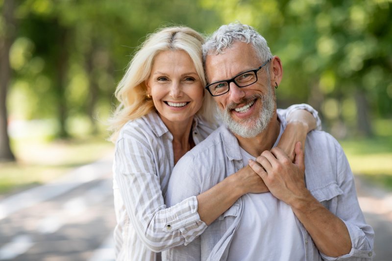 middle-aged couple smiling and hugging each other