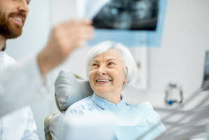 Dentist reviewing X-ray with patient