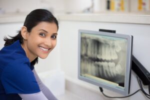Dental staff member viewing a patient’s X-rays